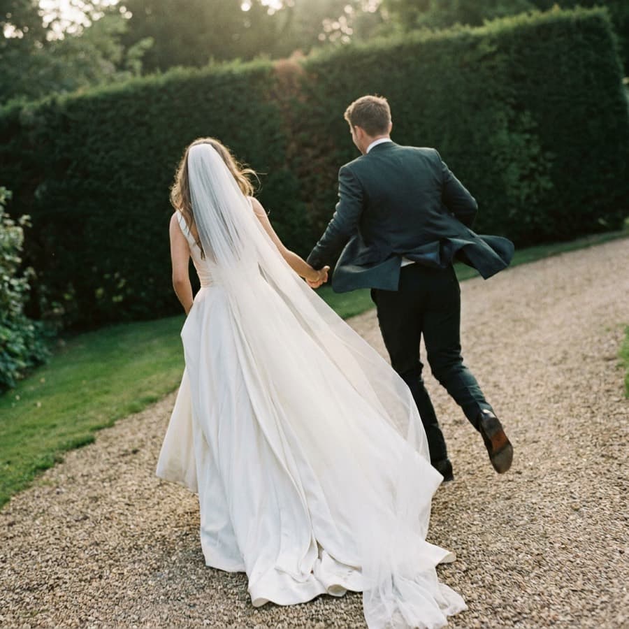 A couple walking away down a gravel path